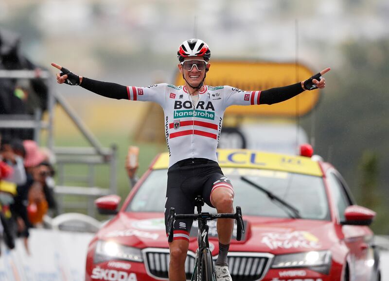 Bora–Hansgrohe rider Patrick Konrad celebrates as he crosses the finish line to win Stage 16 of the Tour de France on Tuesday, July 13.