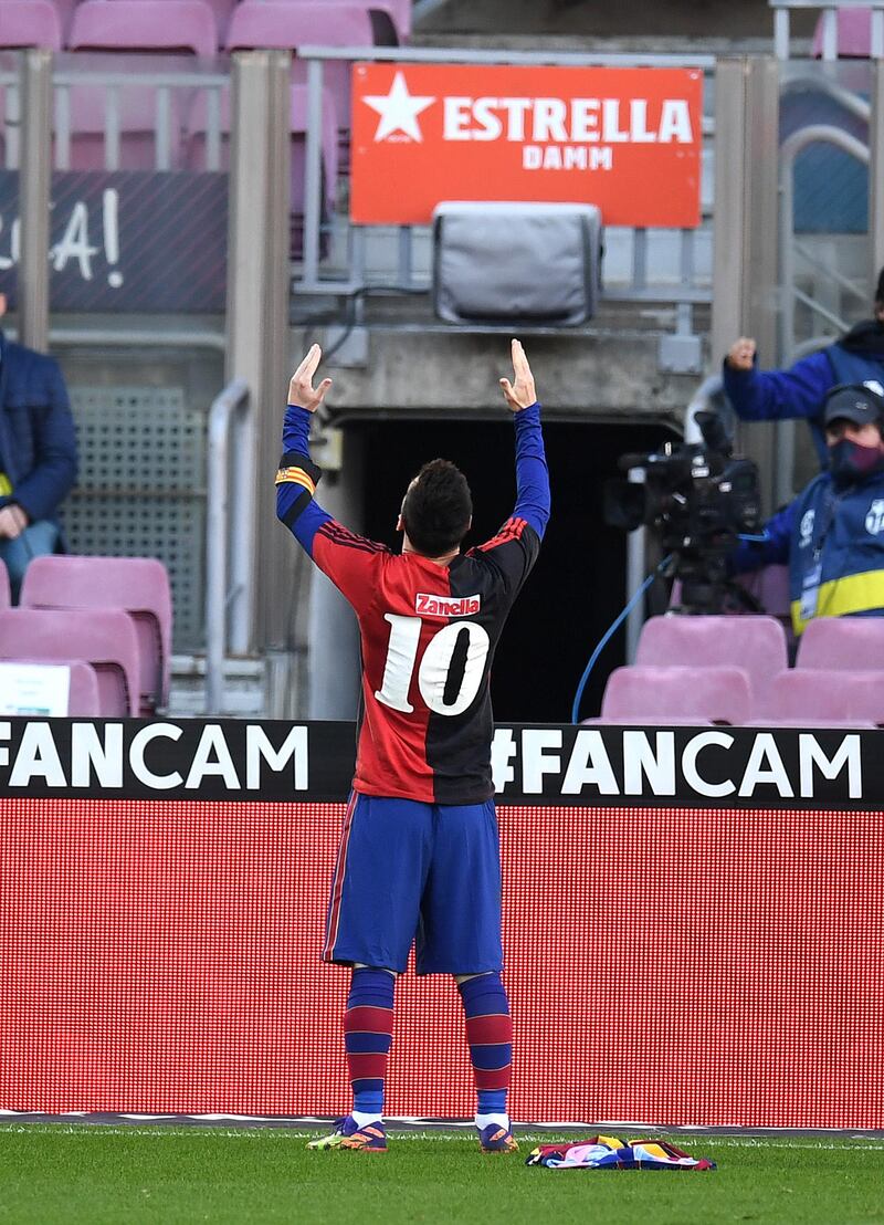 Lionel Messi of Barcelona celebrates after scoring their sides fourth goal while wearing a Newell's Old Boys shirt with the No 10 on the back in memory of Diego Maradona. Getty