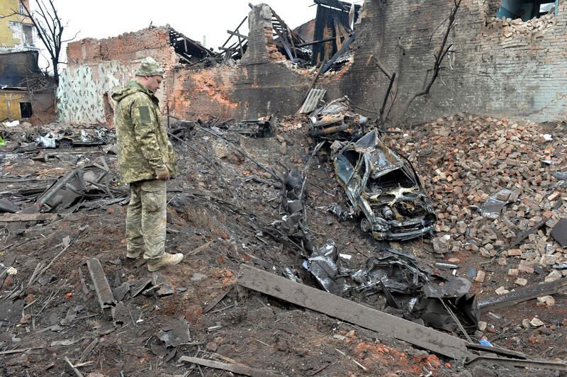 A Ukrainian soldier looks at the destruction after shelling in Ukraine's second-largest city of Kharkiv. AFP
