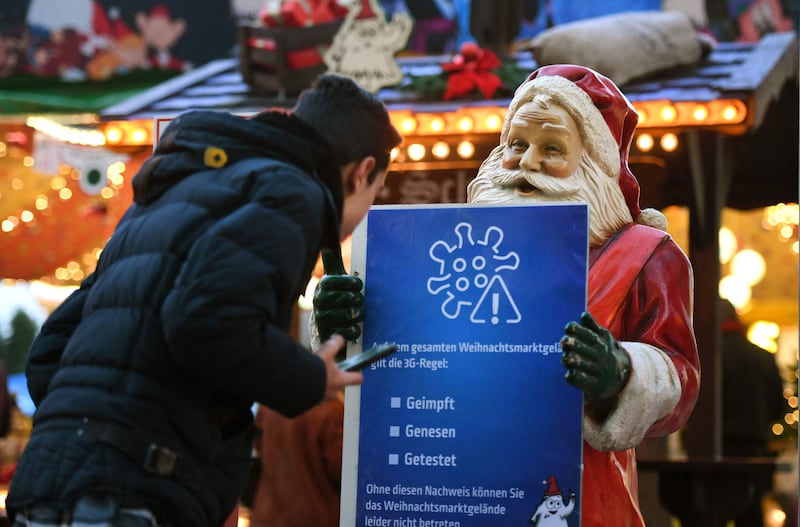 A Father Christmas figure holds Covid-19-related hygiene instructions for visiting the Christmas market in Hagen, western Germany. AFP