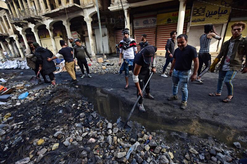 Iraqi protesters clean the site of their protests at the Al Rasheed street in central Baghdad.  EPA