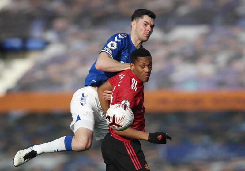 Michael Keane of Everton takes on Anthony Martial. EPA