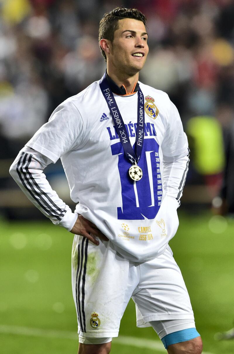 Real Madrid's Portuguese forward Cristiano Ronaldo celebrates their victory at the end of the UEFA Champions League Final Real Madrid vs Atletico de Madrid at Luz stadium in Lisbon, on May 24, 2014. Real Madrid won 4-1.  AFP PHOTO/ MIGUEL RIOPA (Photo by MIGUEL RIOPA / AFP)