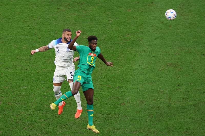 Kyle Walker of England jumps for the ball with Boulaye Dia of Senegal. Getty 