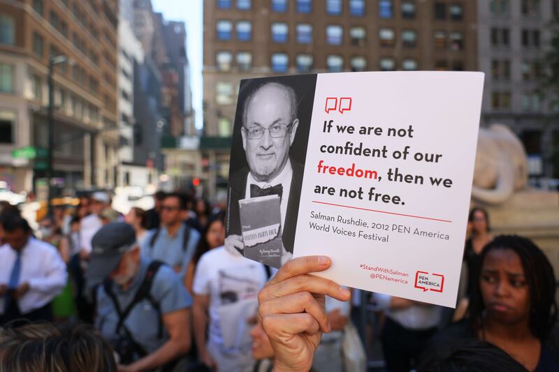 A supporter holds up a placard at a rally in New York in solidarity with Sir Salman Rushdie. AFP