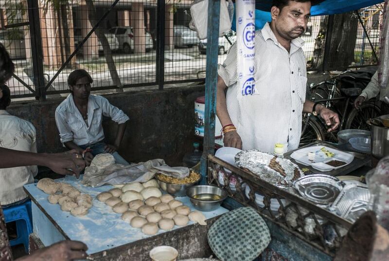 Rajeev Kumar, 40, runs his food stall in New Delhi. Sami Siva for The National