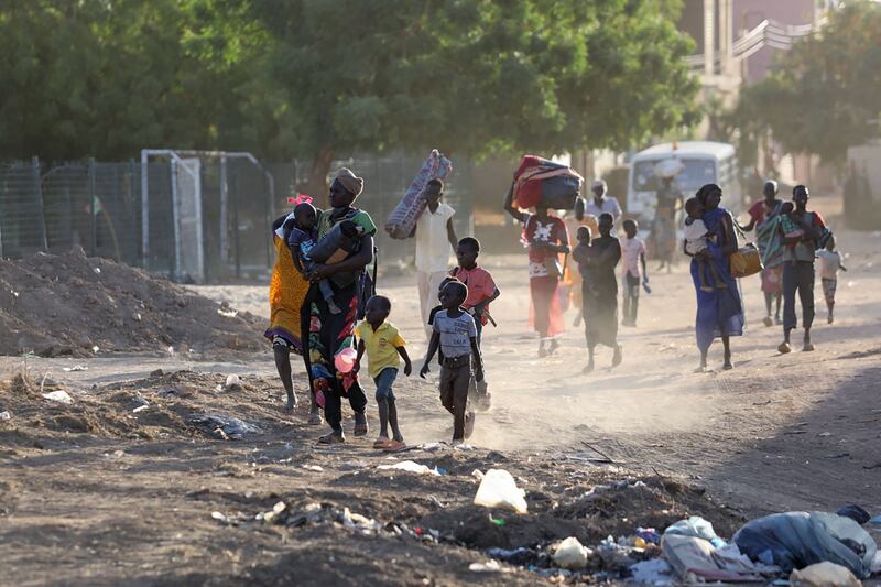 People flee their neighbourhoods amid fighting between the army and RSF in Khartoum on April 19. AFP