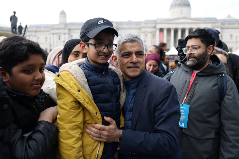 London Mayor Sadiq Khan poses for a photo with Harris Farid, 7. Reuters