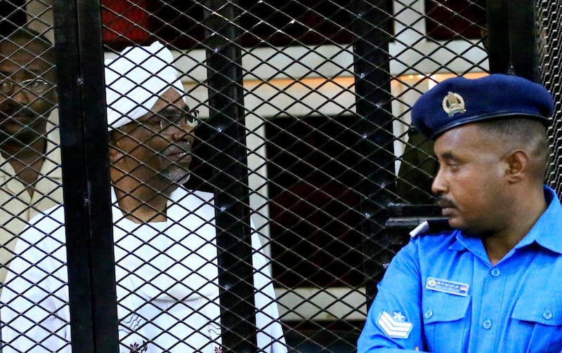 FILE PHOTO: Sudan's former president Omar Hassan al-Bashir sits inside a cage during the hearing of the verdict that convicted him of corruption charges in a court in Khartoum, Sudan, December 14, 2019. REUTERS/Mohamed Nureldin Abdallah/File Photo