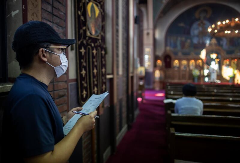 A Seoul city official (L) visits a church in the capital to check if the stricter anti-COVID 19 guidelines for churches are well observed in Seoul, South Korea.  EPA