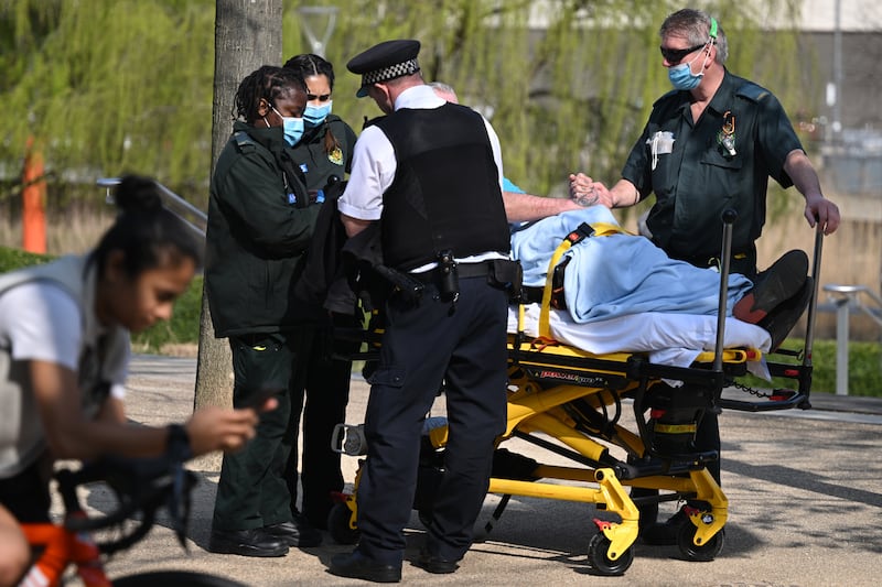 A person is treated by paramedics after London Aquatics Centre was evacuated and cordoned off. Getty Images
