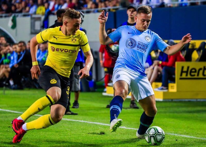 Manchester City's Luke Bolton in action against Borussia Dortmund's Jacob Bruun. EPA