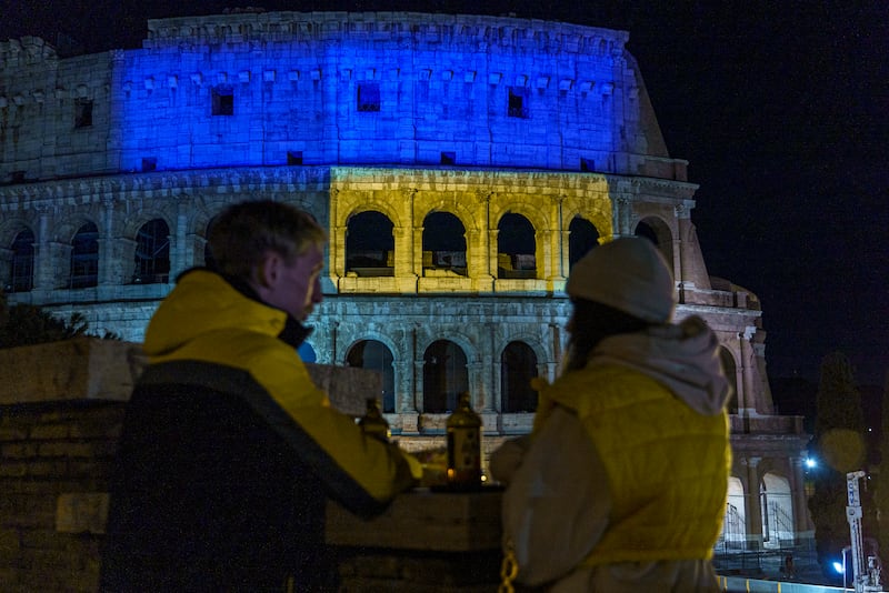 People show solidarity with the people of Ukraine outside the Colosseum in Rome. AP Photo