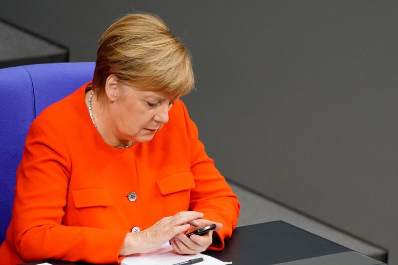 epa07261364 (FILE) - German Chancellor Angela Merkel of the Christian Democratic Union (CDU) checks her mobile phone during a Bundestag session in Berlin, Germany, 27 September 2018 (reissued 04 January 2019). Reports on 04 January 2019 state personal data of  hundreds of German politicians including Chancellor Merkel have been hacked and posted online. The data includes credit card information, private chats and contact information. The only party whose members have not seen their private information posted online is the far-right AfD party.  EPA/ALEXANDER BECHER