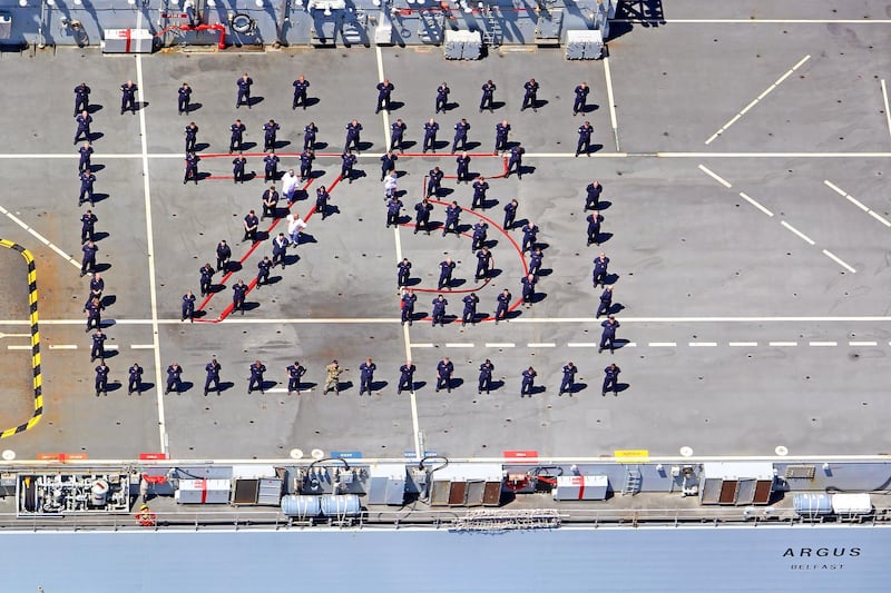 An undated handout photo made available by the British Ministry of Defence of the crew made up of Royal Fleet Auxiliary, Royal Marines, Royal Engineers, and Royal Navy personnel including units from 815 and 845 Naval Air Squadrons, marking out '75', referring to the 75th anniversary of the end of the Second World War in Europe.  EPA