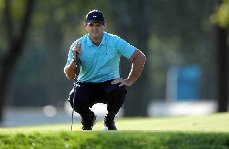 Patrick Reed looks over his putt on the second green. USA Today