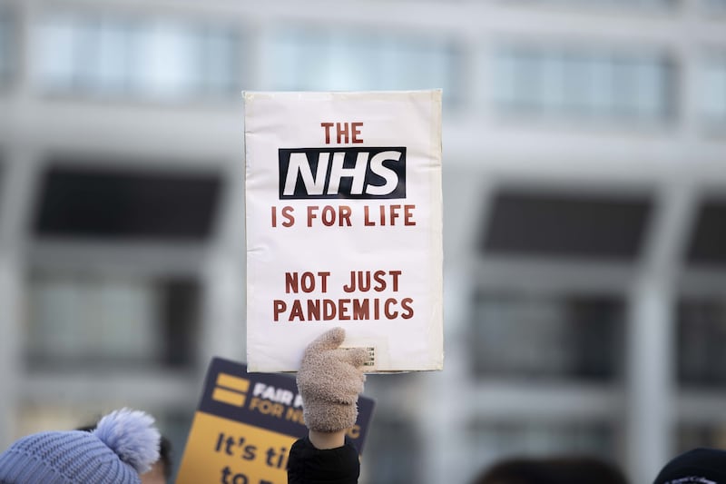 Demonstrators, holding placards and banners, during a strike by NHS nursing staff outside St. Thomas' Hospital in London, in 2022. Getty Images