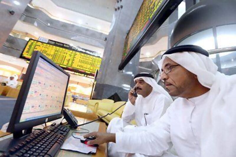 Traded value on the country's bourses reached Dh119.97 billion in the second quarter. Above, investors monitor trading on the Abu Dhabi stock market. Ben Job / Reuters