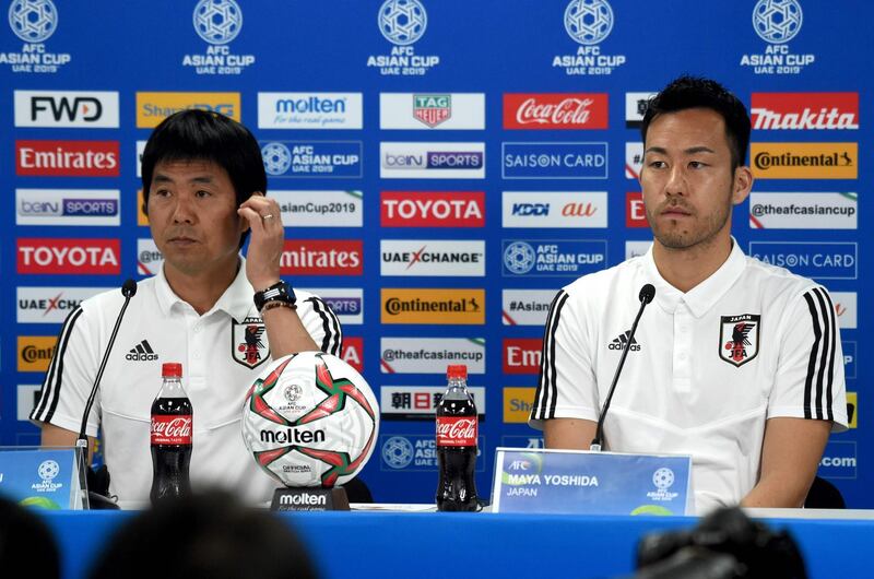 Japan's player Maya Yoshida (R) with head coach Hajime Moriyasu (L) attend the pre-match press conference ahead of the AFC Asian Cup final match against Qatar at the Zayed Sports City Stadium in Abu Dhabi on January 31, 2019. While Japan have the Asian Cup pedigree, Qatar's over-achieving players might just feel that their name is on the trophy after a record-breaking run to their first-ever final. / AFP / Roslan RAHMAN
