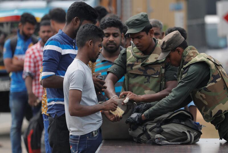 Sri Lankan army personnel search people and their bags at a check point in Kattankudy near Batticaloa, Sri Lanka April 28, 2019. REUTERS/Dinuka Liyanawatte