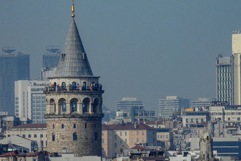 Tourists visit the top of the Galata tower in Istanbul on April 30, 2021, during a lockdown aimed at fighting a surging third wave of Covid-19 infections. - Turkey enter "a full closure" from April 29 to May 17, that requires people to stay indoors without a valid reason and sees all non-essential businesses closed. The nation of 84 million has seen daily Covid-19 death tolls rise to around 350 -- higher than during two previous spikes last year. (Photo by Ozan KOSE / AFP)