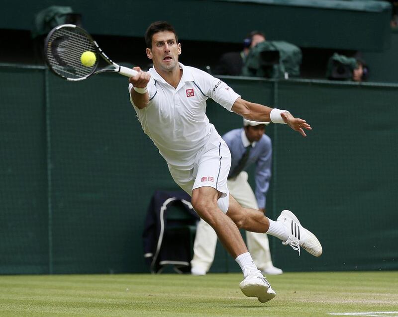 Novak Djokovic of Serbia hits a shot during the Wimbledon men's final against Roger Federer of Switzerland in London, July 12, 2015. REUTERS/Stefan Wermuth 