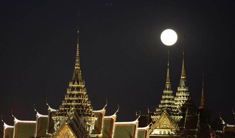 The moon rises over the Grand Palace in Bangkok, Thailand. Sakchai Lalit / AP Photo