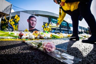 A Nantes supporter puts down flowers as a tribute to Emiliano Sala. AFP