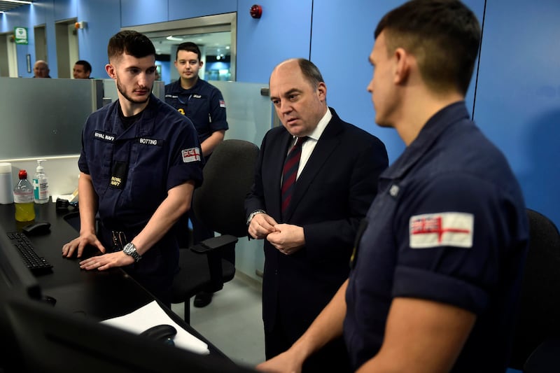 UK Defence Secretary Ben Wallace, centre, at Manchester airport in December meeting members of the military covering for striking Border Force officers. AP