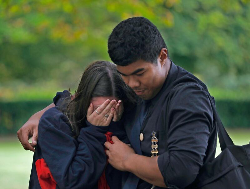 A mourner reacts after paying her respects outside Al Noor mosque. AP Photo