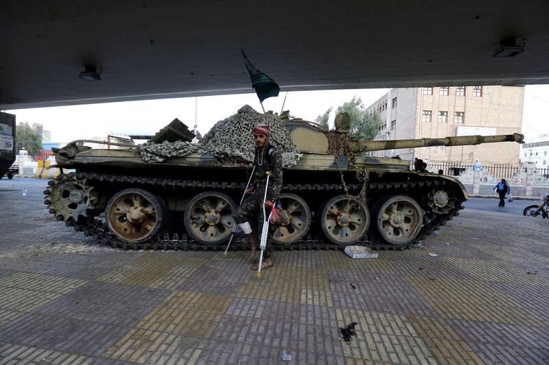 A wounded Houthi fighter walks past a tank at a street leading to the house of Yemeni ex-president Ali Abdullah Saleh. Saleh was killed in Sanaa, Yemen on December 4. Yahya Arhab / EPA
