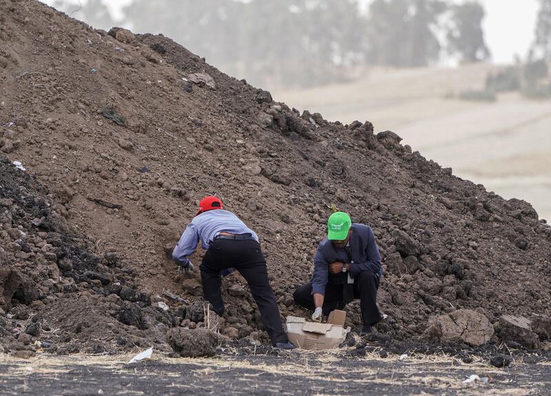 ADDIS ABABA, ETHIOPIA - MARCH 14:  Ethiopian Airlines officials collect soil from the crash site to give to Family members visiting the crash site of Ethiopian Airlines Flight ET302 on March 14, 2019 in Ejere, Ethiopia. All 157 passengers and crew perished after the Ethiopian Airlines Boeing 737 Max 8 Flight came down six minutes after taking off from Bole Airport. (Photo by Jemal Countess/Getty Images) pay their respects at the crash site of Ethiopian Airlines Flight ET302 on March 14, 2019 in Ejere, Ethiopia. All 157 passengers and crew perished after the Ethiopian Airlines Boeing 737 Max 8 Flight came down six minutes after taking off from Bole Airport. (Photo by Jemal Countess/Getty Images)
