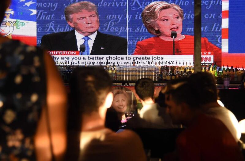 Clinton supporters watch the first US presidential debate between Democratic candidate Hillary Clinton and Republican Donald Trump, at a debate watch party at The Abbey bar and restaurant in West Hollywood, California, September 26, 2016.   / AFP / Robyn Beck

