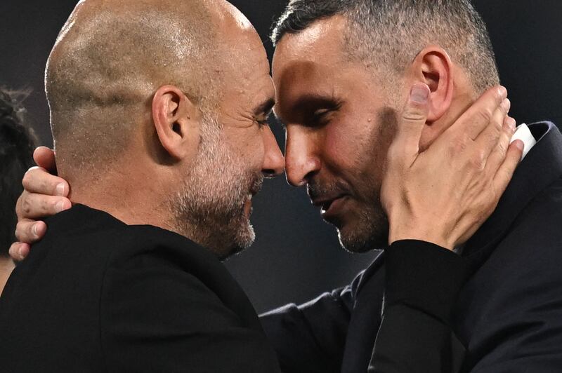 Manchester City's Spanish manager Pep Guardiola (L) celebrates with Manchester City's Emirati chairman Khaldoon al-Mubarak after the UEFA Champions League final football match between Inter Milan and Manchester City at the Ataturk Olympic Stadium in Istanbul. AFP