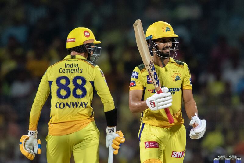 Chennai Super Kings' Ruturaj Gaikwad, right, raises his bat to acknowledge his fifty runs as Devon Conway looks at him during the Indian Premier League qualifier cricket match between Chennai Super Kings and Gujrat Titans in Chennai, India, Tuesday, May 23, 2023.  (AP Photo /R.  Parthibhan)