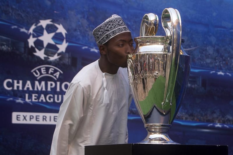 Kenyan Ali Muhidin Ali kisses the UEFA Champions League trophy that was on display at Yas Mall yesterday. Christopher Pike / The National