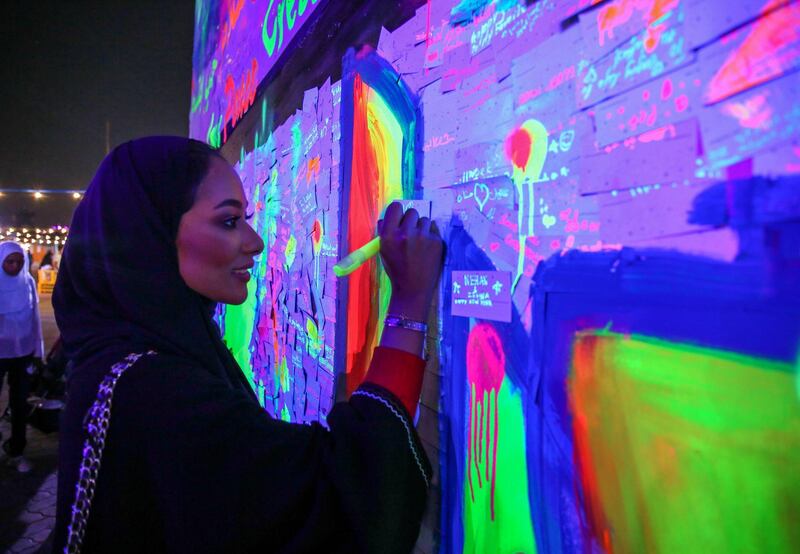 Abu Dhabi, United Arab Emirates, December 31, 2017.   New Year's Eve At the Abu Dhabi New Year's Eve Village.  Anoud Ali writes her wish on the Wishing Wall.
Victor Besa for The National.
National
Reporter:  John Dennehy