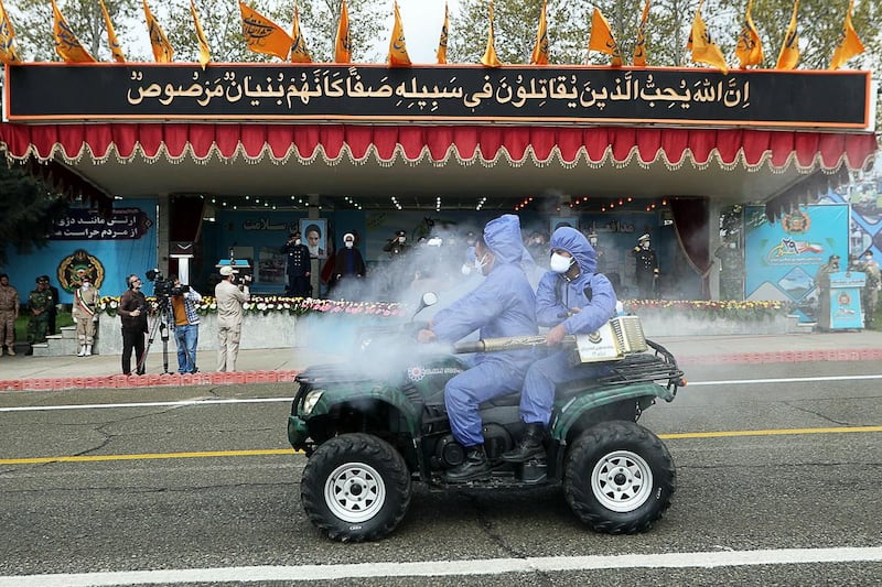 Soldiers wearing protective face masks as they parade amid the ongoing coronavirus pandemic. Iranian military via EPA, HO