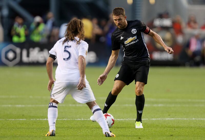 Manchester United captain Michael Carrick, right, in action. Jim Urquhart / Reuters