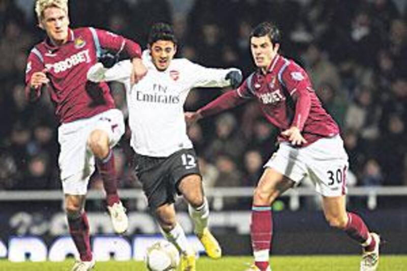 Carlos Vela, centre, attempts to break through past the shackles.
