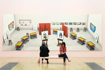 LONDON, ENGLAND - JUNE 05:  Two woman take a seat in front of "Seven Trollies, Six and a Half Stools, Six Portraits, Eleven Paintings, and Two Curtains" by David Hockney during a press preview of the 250th Summer Exhibition at Royal Academy of Arts on June 5, 2018 in London, England.  The Summer Exhibition runs from 12 June to 19 August 2018 and allows established and emerging artists to display their work, side by side, with all forms of contemporary art, including such mediums as sculpture, painting, video installation and textile.  (Photo by Leon Neal/Getty Images)