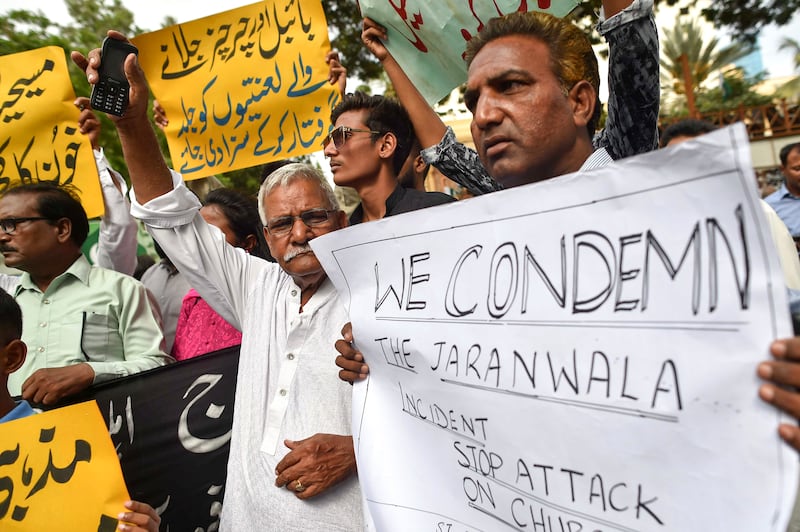 Members of the Christian community hold placards during a protest against the Faisalabad mob violence incidents, in Karachi, Pakistan, 18 August 2023.  Armed mobs in Jaranwala targeted two churches and private homes, setting them on fire and causing widespread destruction.  The violence was sparked by the discovery of torn pages of the Muslim holy book of Koran with alleged blasphemous content near a Christian colony.   EPA / SHAHZAIB AKBER