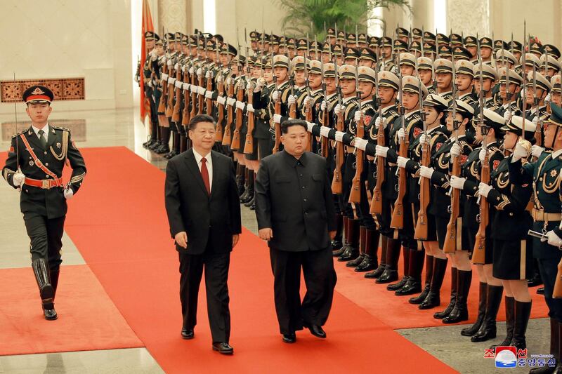 North Korean leader Kim Jong Un and Chinese President Xi Jinping inspect honour guards, as he paid an unofficial visit to Beijing, China. KCNA / via Reuters