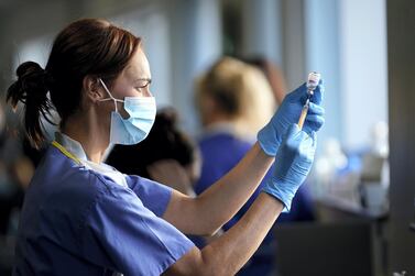 A nurse draws the Oxford-AstraZeneca Covid-19 coronavirus vaccine into a hypodermic needle at a vaccination centre in St Helen's, Merseyside, north-west England. Getty images