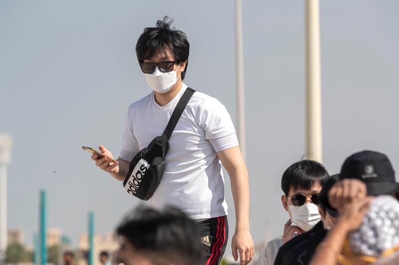DUBAI, UNITED ARAB EMIRATES. 29 JANUARY 2020. Tourists and sightseers wear facial masks on Sunset Beach next to the Burj Al Arab and Jumeirah Beach Hotel.  (Photo: Antonie Robertson/The National) Journalist: Standalone. Section: National.