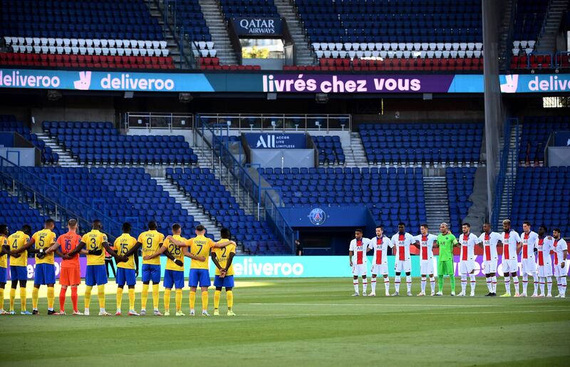 Paris Saint-Germain's players and Sochaux players observe a minute's silence.  AFP