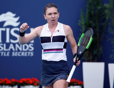 Simona Halep, of Romania, celebrates her victory against Wang Qiang, of China, at the Miami Open tennis tournament, Wednesday, March 27, 2019, in Miami Gardens, Fla. (AP Photo/Joel Auerbach)