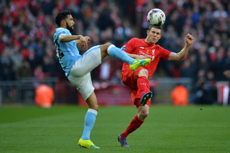 Manchester City’s French defender Gael Clichy vies with Liverpool’s English midfielder James Milner (R) during the League Cup final football match between Liverpool and Manchester City at Wembley Stadium in London on February 28, 2016. AFP / GLYN KIRK