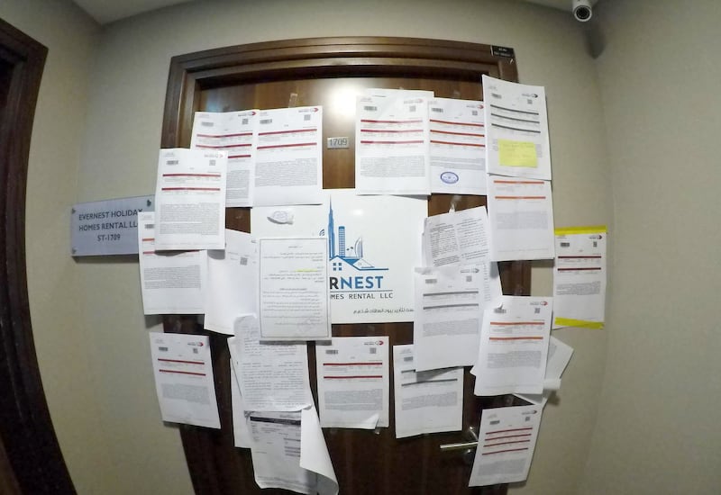 Its office door is littered with legal notices including from government departments. Dubai's rental regulator said it has launched a probe. Pawan Singh / The National