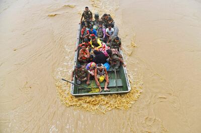 The army evacuate flood-affected villages after heavy rains in the Hojai district of India's Assam state. AFP